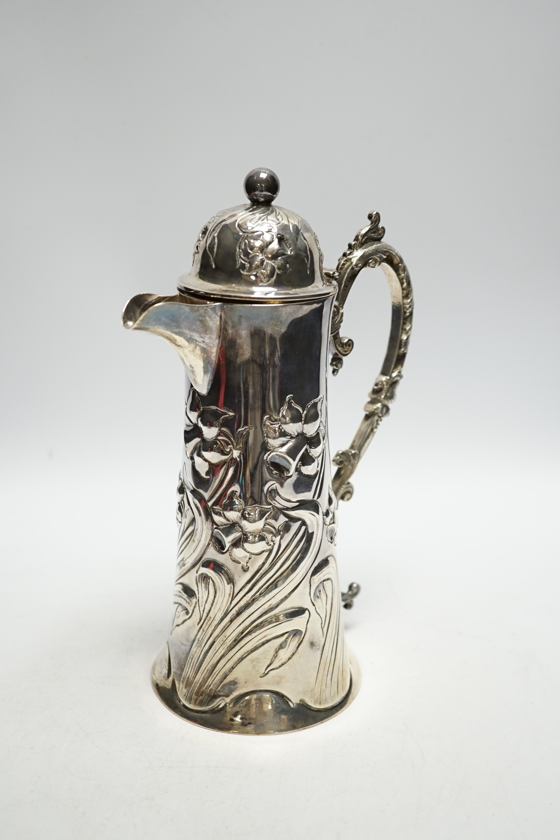 A late Victorian embossed silver jug, John Henry Potter, Sheffield, 1900, height 24.8cm, with replaced plated handle?, gross weight 22.6oz.